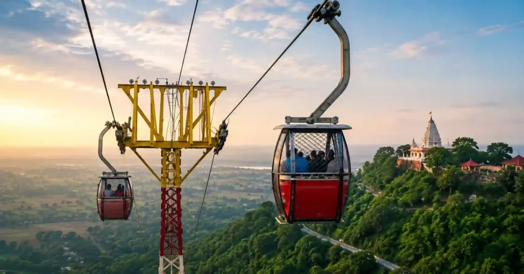 Ropeway carrying devotees to Maa Sharda Maihar Temple on Trikuta Hill with panoramic views of the surrounding valley and forests.